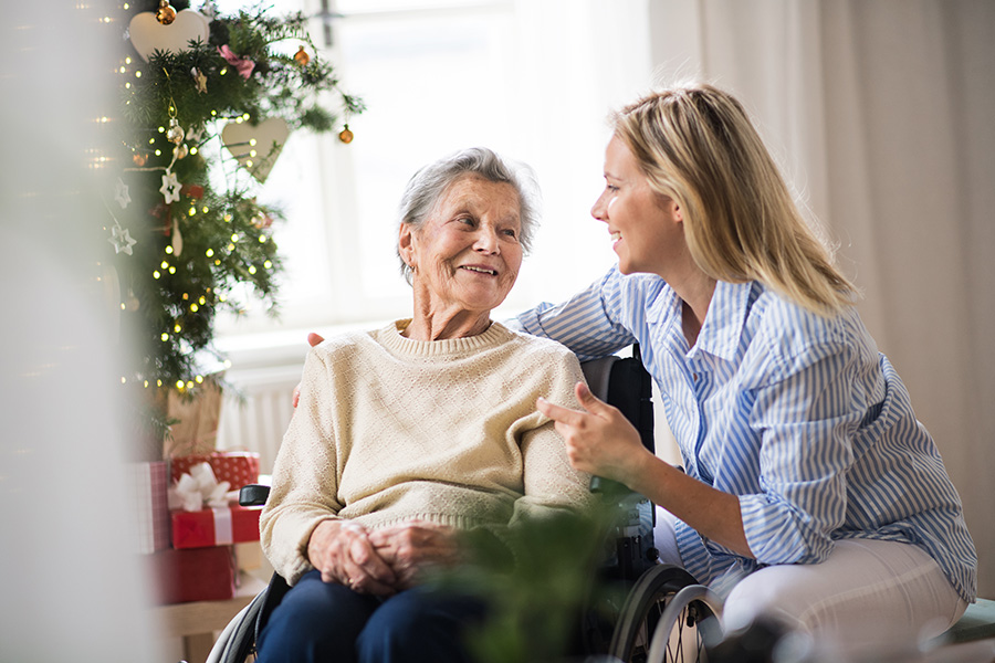 older woman in wheelchair with younger woman talking